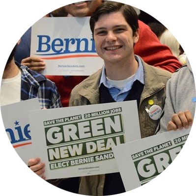 Anthony holding a sign for the Green New Deal